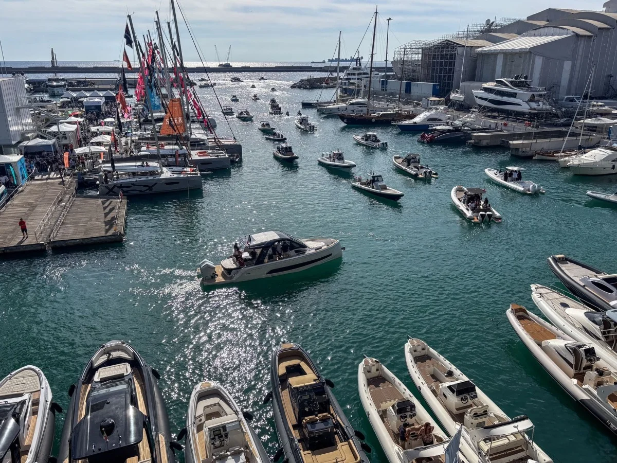 Scena sullo specchio d'acqua con numerosi gommoni e imbarcazioni in movimento, riflessi sul mare.