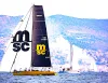 Imbarcazione da regata Psaros 33 con grandi loghi MSC sulle vele e murata in regata