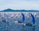 Flotta di J/70 con gennaker colorati in regata davanti alle coste di Porto Cervo