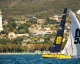 Psaros33 gialla e nera di MSC con spinnaker bianco in regata davanti a Trieste