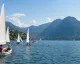 Derive con equipaggi in acqua sul Lago di Lugano, con le montagne del Ceresio sullo sfondo